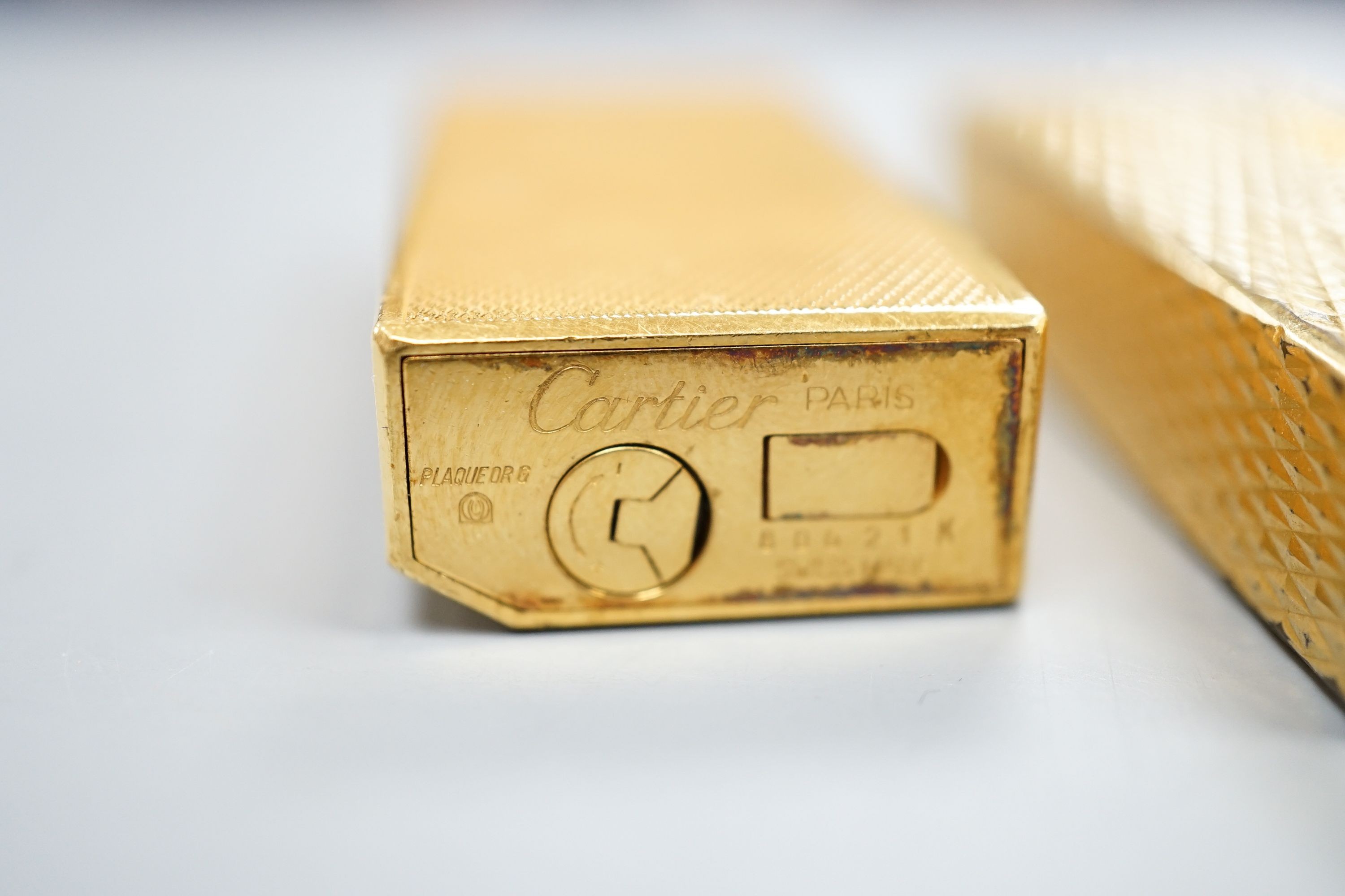 A gold plated Cartier lighter and a similar Dupont lighter